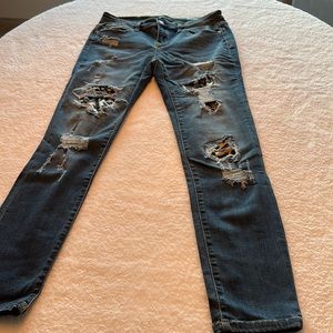 Judy Blue size 9/29 distressed skinny jeans with leopard patches.